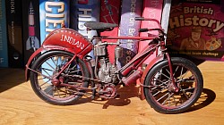 Just a photograph of an ornamental bike on the bookshelf